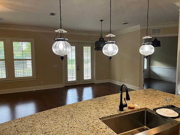 View through open living dining area to outdoor patio