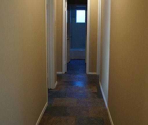 slate tile hall leading to bedrooms