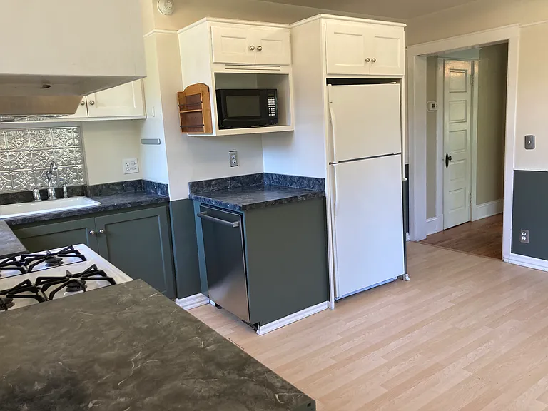 Kitchen with new Bosch diswasher, gas range, top end range hood.