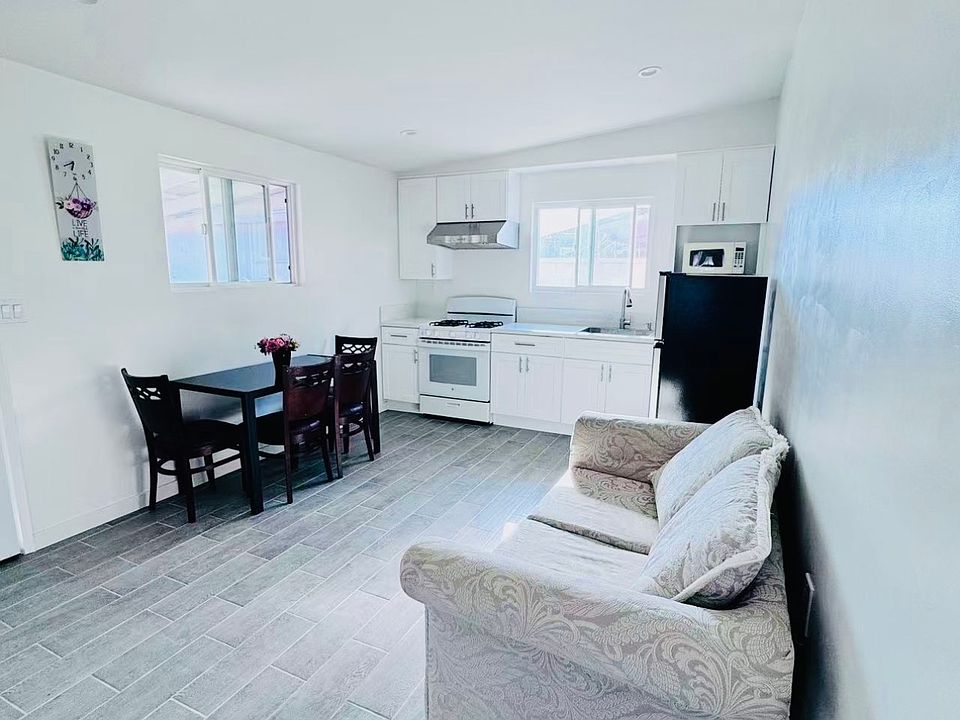 Bright open-concept living area with modern kitchen and dining space