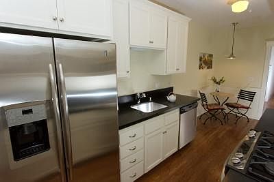 Galley kitchen with GE stainless appliances, honed granite counters and room for a breakfast table.