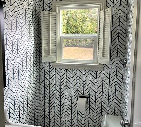 Downstairs half bathroom. Updated recently with wallpaper and new tile floor.