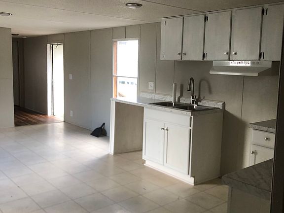 New bottom cabinets, countertops, sink and faucet.