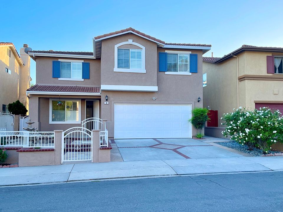 Front of the house with gated fence and entry.