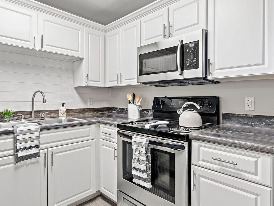 Elegance flows with designer kitchens featuring subway tile backsplash.