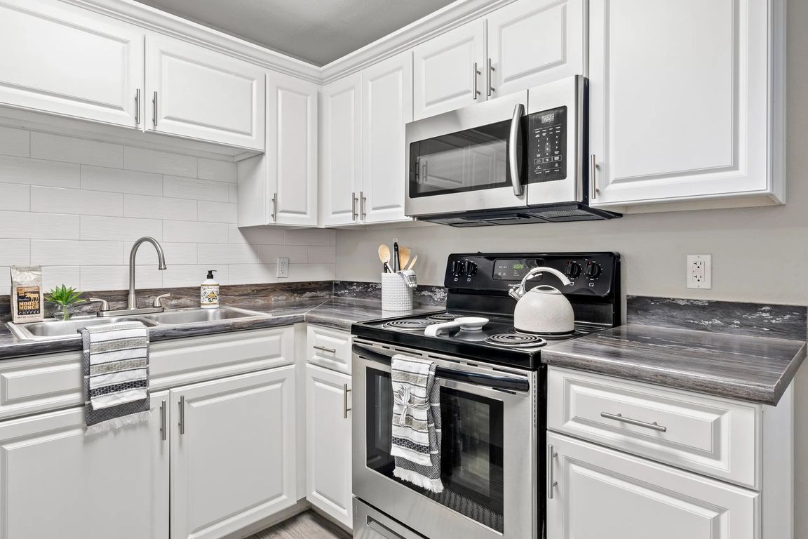 Elegance flows with designer kitchens featuring subway tile backsplash.