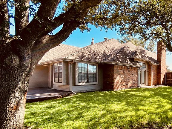 Large Yard with Oak Trees side yard & Patio. Wood & Brick Privacy Fence.