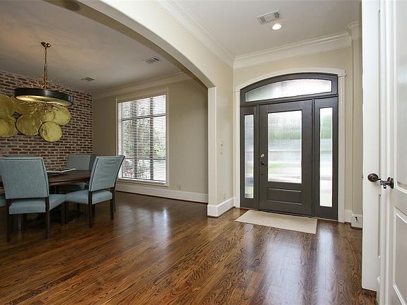 Inviting entry with gleaming wood floors.