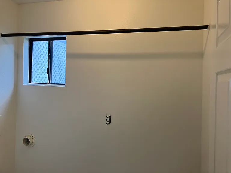 Laundry room with pole with air dry clothes