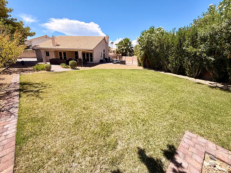 Grass area looking towards side patio and back patio.
