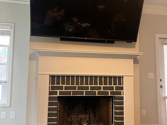 Updated painted brick to match kitchen island. 75 inch TV can be included if renters wish or can be removed to add their own.