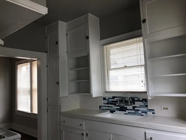Freshly painted kitchen, new tile floors and backsplash.