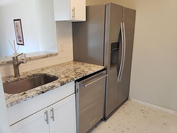 Modern kitchen with new appliances and granite countertops