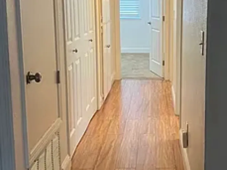 Hallway to bedrooms laundry closet, linen closet and second bathroom.
