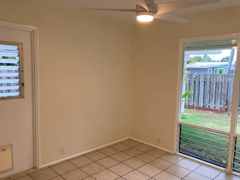 Corner bedroom with door opening to pool deck with a cat door in it.