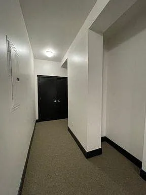 Halllway with white walls and black trim at 3 Points Loft.