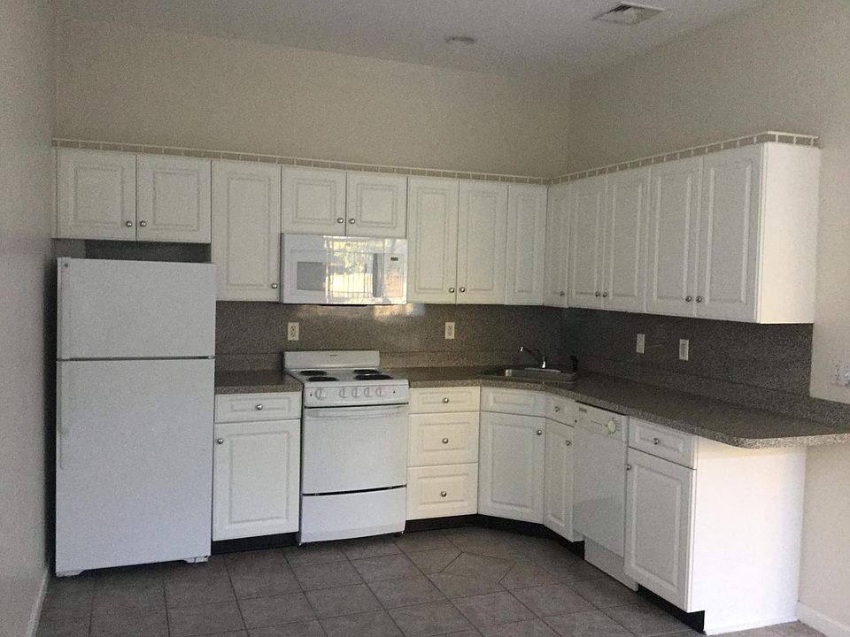 Full kitchen with range, microwave and dishwasher.
