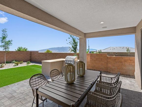 Beautiful backyard and covered patio perfect for summer BBQs and dining al fresco.