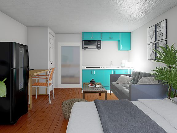 Explore this contemporary studio designed for comfort, with a vibrant kitchen and cozy seating area.