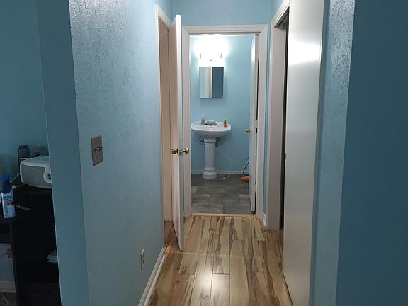 Top of spiral staircase; looking into bathroom from bedroom. Paler blue paint now.