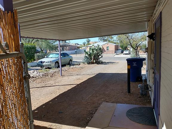 View from the side gate towards to carport. There's a fence now that blocks the view of the neighbor's car.