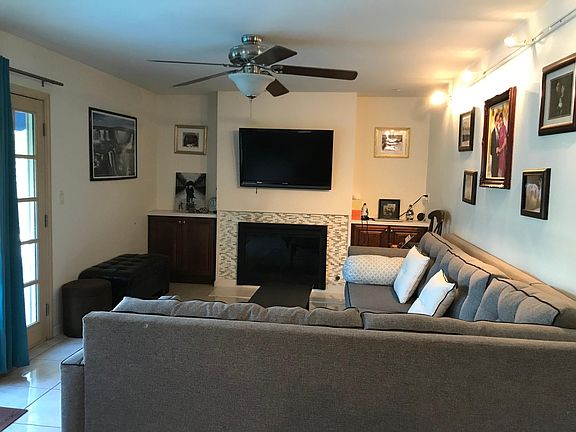 Newly remodeled family room with quartz counters, new cabinets, backsplash around new fireplace