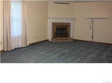 Living room showing corner gas fireplace