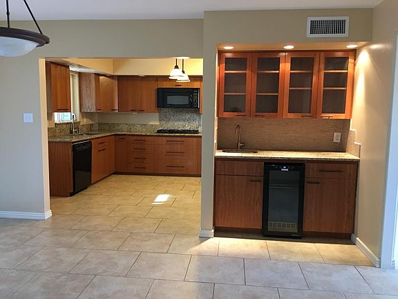 Wet bar in dining room and partial view of kitchen