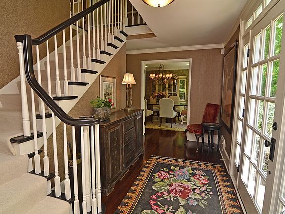 Welcome guests in this dazzling foyer with grand staircase & cherry floors.