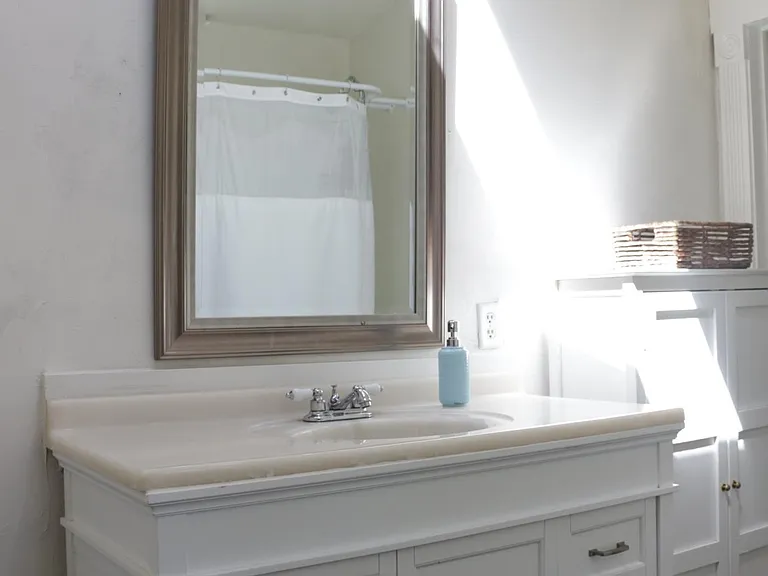 The main bathroom has a decades-old, renovated clawfoot iron tub. You'll find another VeLux skylight as well as other custom windows that bathe the room in natural light.