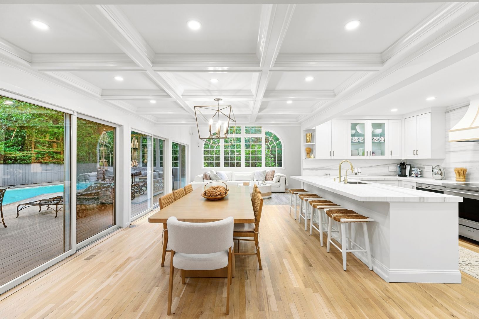  DINING WITH COFFERED CEILING MARBLE COUNTER TOPPED  BREAKFAST BAR.  SLIDERS TO DECK AND GUNITE POOL.