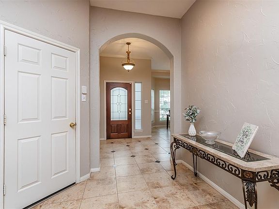 You can see the chandelier in the foyer and to the left is your access to the 2 car garage. This space flows through the family living space.