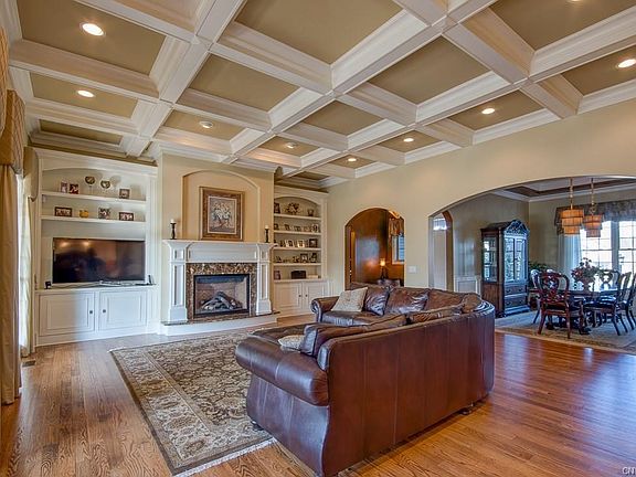 11' coffered ceiling gives great room that wow factor.  Proportional trim matters.  See how ceiling effortlessly meets built-ins on hearth wall.  Perfection.