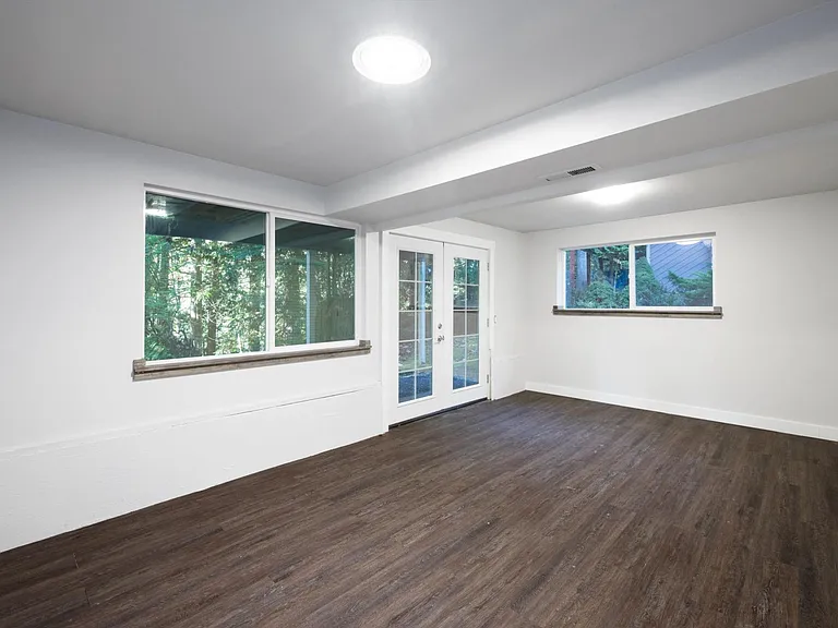 Lower level with french doors to patio can also be a bedroom also with laundry room & closet