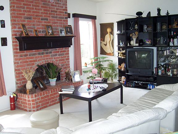Living room with large brick fireplace