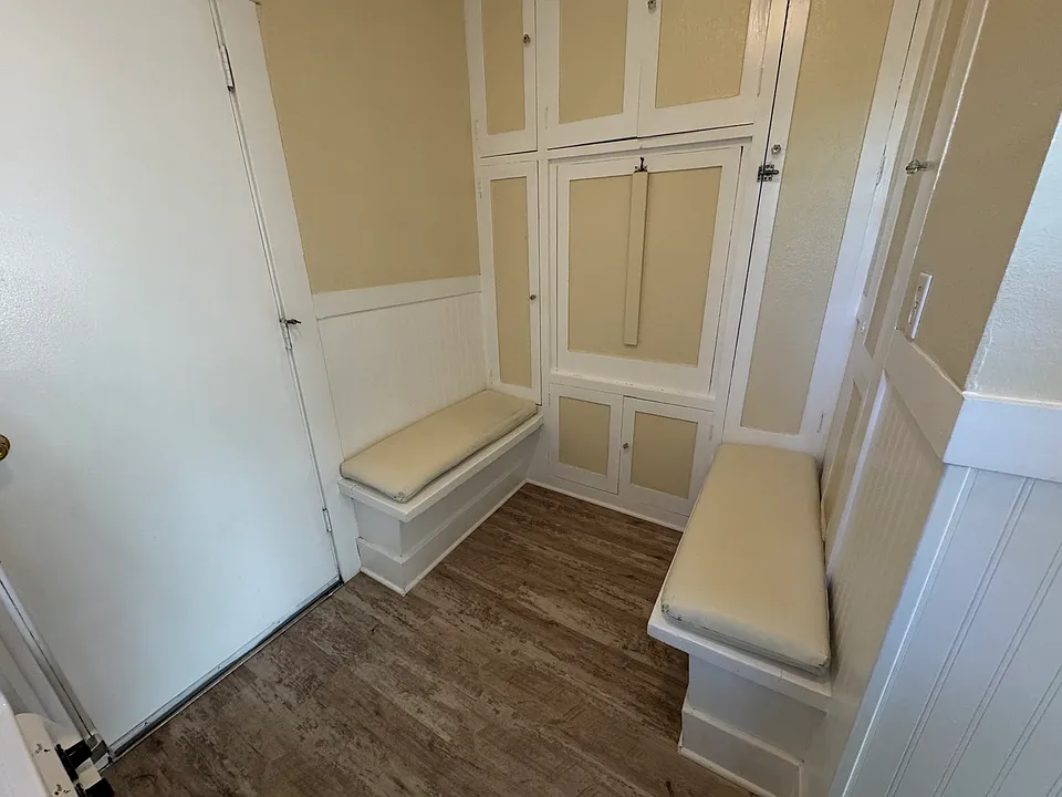 Eat in kitchen with bench seats, cushions and drop-down table shown in the closed position.