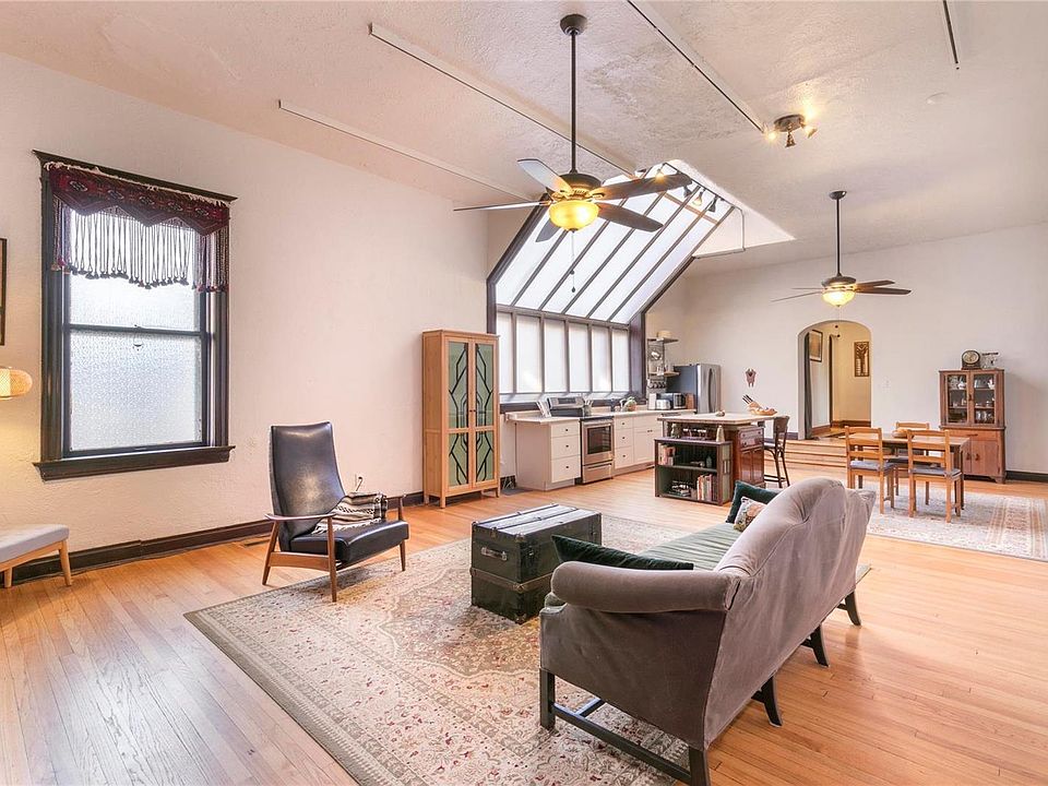 Open Kitchen and Living area, with amazingly tall ceilings, hardwood flooring, and stainless steel appliances.