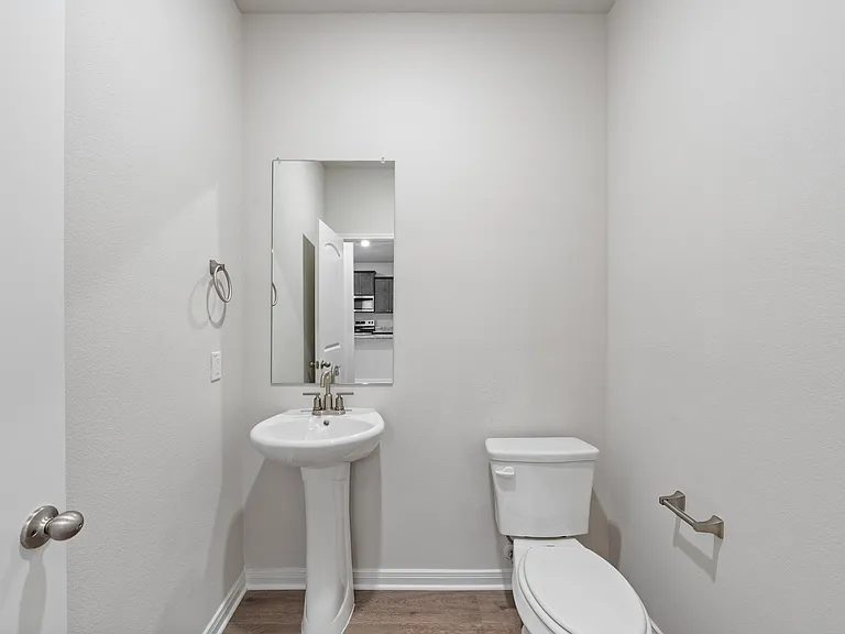 The downstairs powder room sits right off of the living room.
