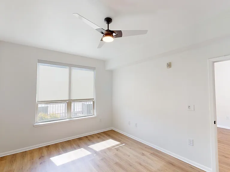 Spacious apartment Bedroom with Wood Style Flooring.