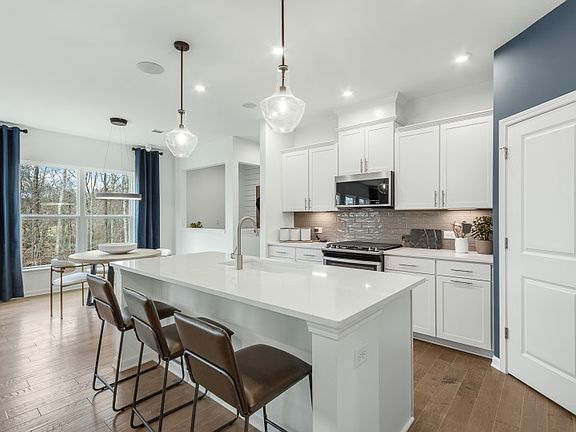 Luxurious Kitchen with Stainless Steel Appliances and Tile Backsplash