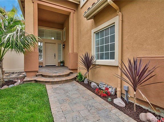 Private Entry with Brick Paver Walkway, Porch with Night Lighting.