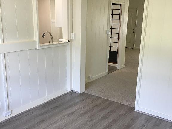 Den toward living room and kitchen pass-through window.