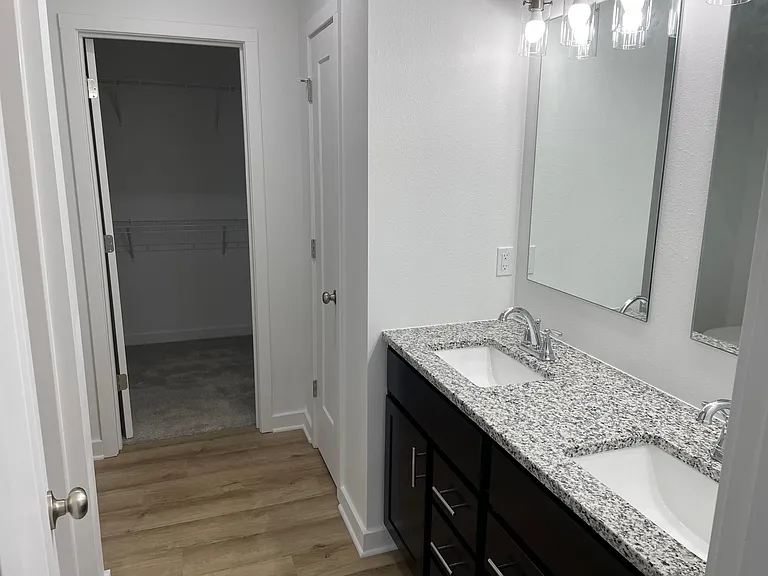 Master bathroon with dual vanities, granite countertop, walk in shower.