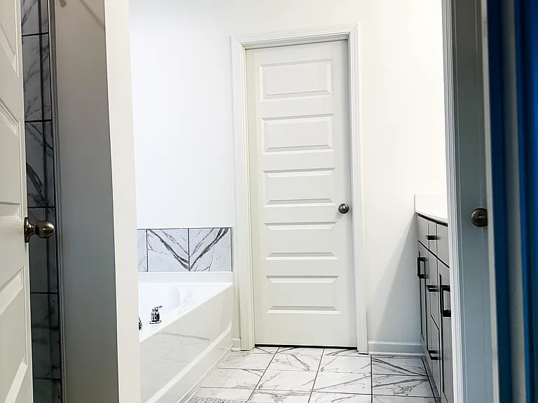 Sleek frameless glass shower door designed for easy cleaning and a modern, open look !