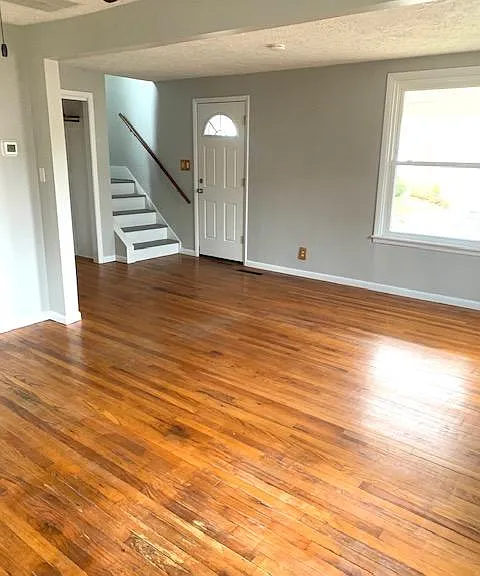 Living Room with hall closet, front entrance, stairwell to 2nd floor