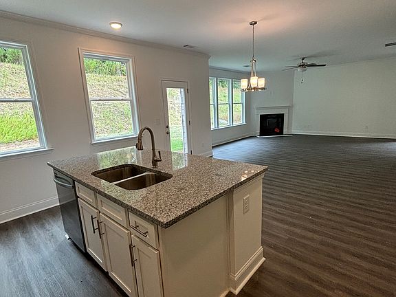 Open kitchen viewing the family room with fire place.