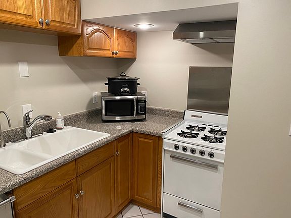 Double sink with disposal, gas stove with venting range hood and microwave
