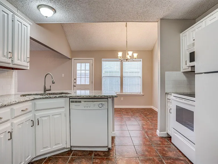 Recent dishwasher and smooth top electric range.