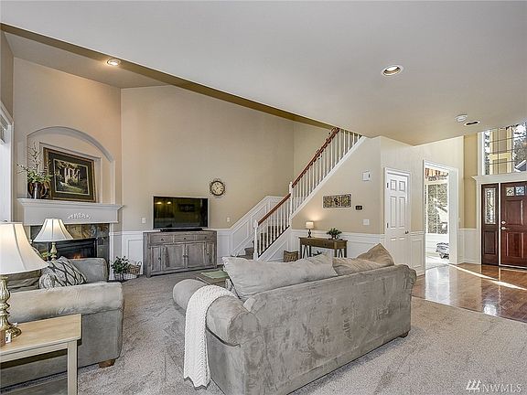 Entry way leads into a large and open living room, beautiful wainscoting and throughout as well as a large statement mantle and gas fireplace! 