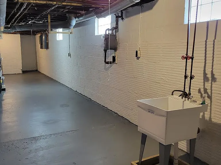 Basement, large, separate and private from other portions of the basement with electric washer and dryer hook ups and block windows.